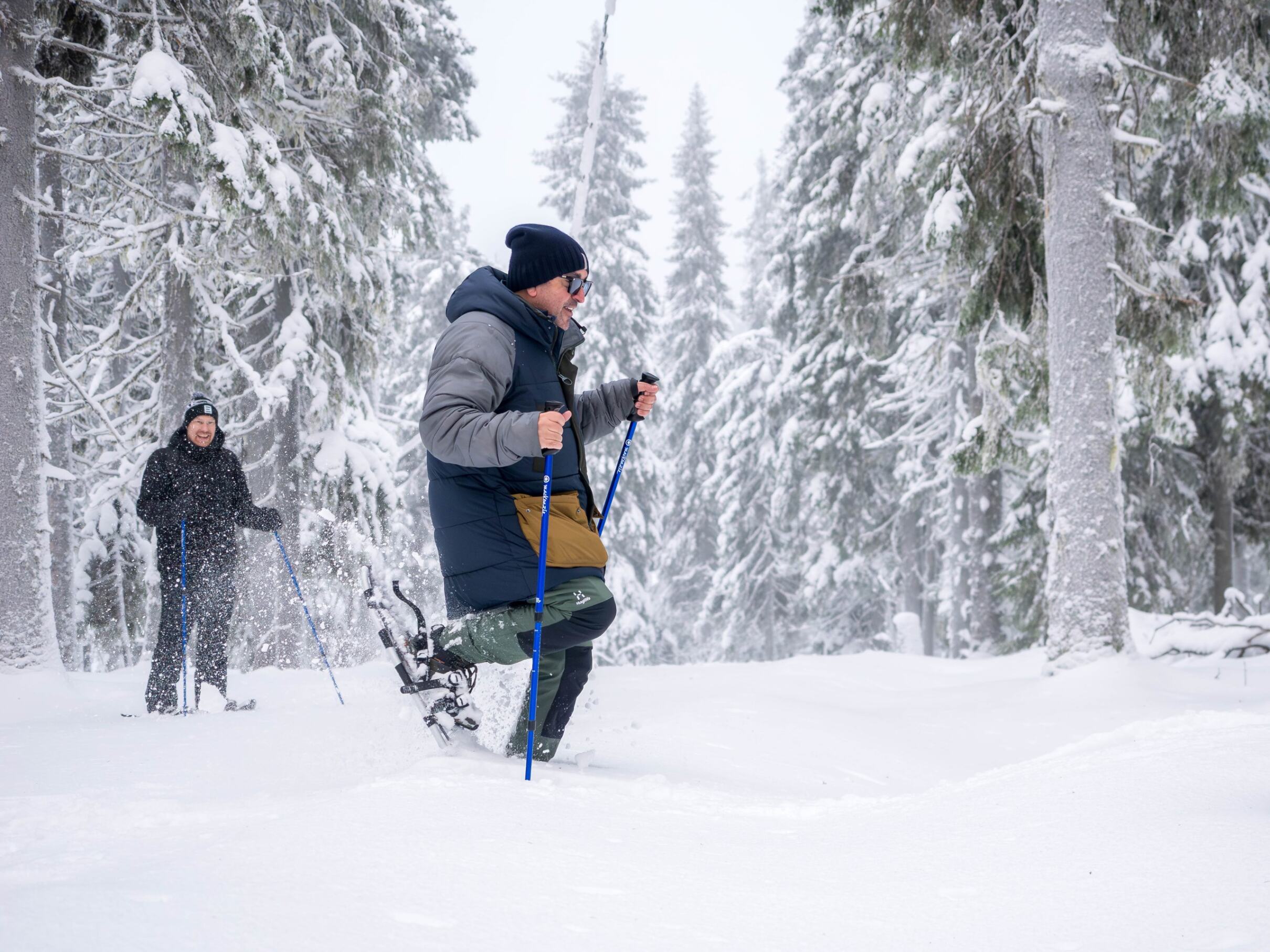 Guided snowshoeing through a snowy Finnish forest
